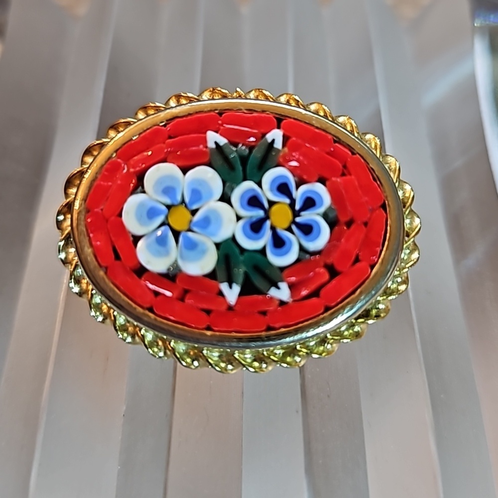 Vintage millefiori micro mosaic flowers pin brooch set in a gold edged frame.
